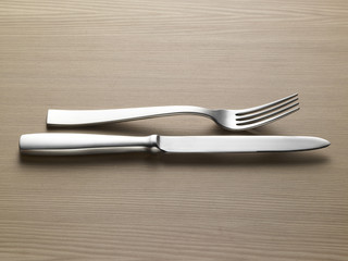fork knife on wooden table - forchetta coltello su legno