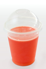 Carrot and berry juice in a plastic takeaway cup