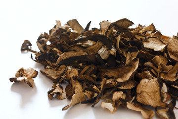 Dried forest mushrooms on white surface