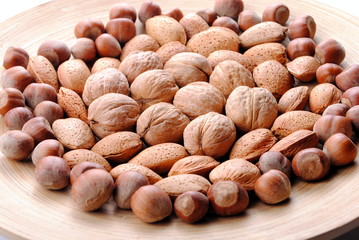 walnuts, almonds and hazelnuts in a round dish