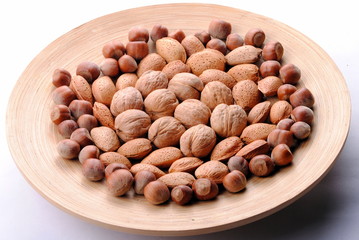 walnuts, almonds and hazelnuts in a round dish