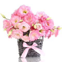 bouquet of eustoma flowers in  wicker vase, isolated on white