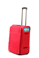 red suitcase with sticker with flag of Sweden isolated on white