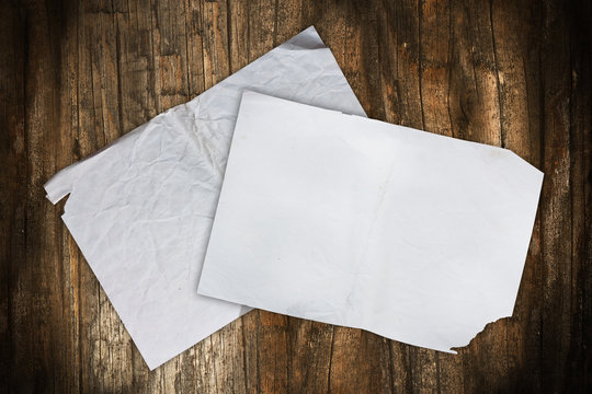 Empty paper sheets on a wooden background