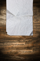 Wrinkled paper roll on a dark wooden background