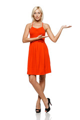 Fototapeta premium Full length of woman showing copy space on her palm