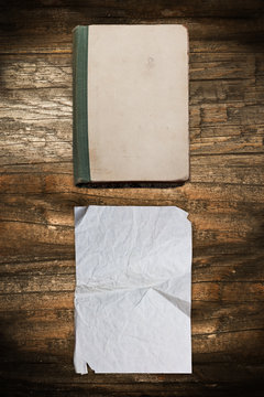 Vintage book and paper sheet on wood