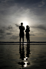 silhouette of couple on beach