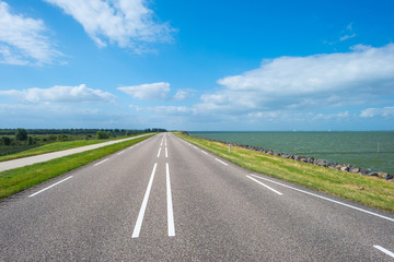 Road on a dike along a lake