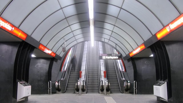 People go on escalator to subway
