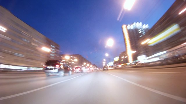 Cars go on high-speed highway in evening
