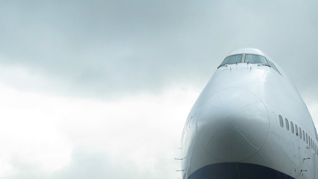 Plane nose is visible against sky close up
