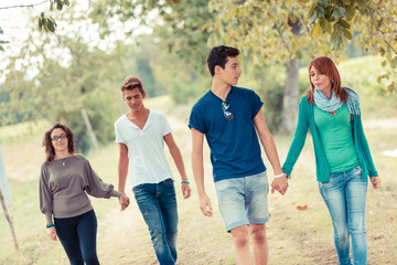 Group of Teenagers Walking Holding Hands