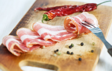 Slices of bacon and fork