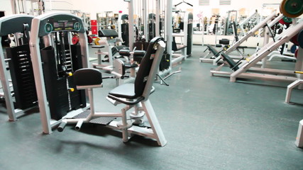 simulator for muscles abdomen in large gym - Powered by Adobe