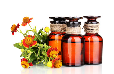 medicine bottles and flowers isolated on white