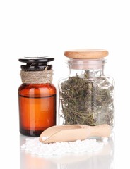 tablets and bottles with herbs and mixture isolated on white