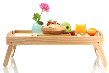 light breakfast on wooden tray isolated on white