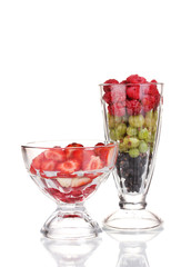 Mixed fruits and berries in glasses isolated on white