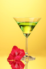 glass with cocktail and gladiolus bud