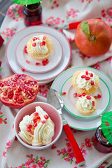 Little cakes with cream and pomegranate