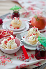 Little cakes with cream and pomegranate