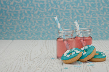 Two glasses with pink lemonade and cookies