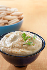 bowl of homemade hummus with breadsticks