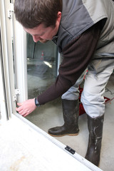 Worker installing a new door