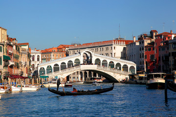 Rialto Bridge with gondola in Venice, Italy