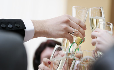 Men's hand holding wine glass at festive event