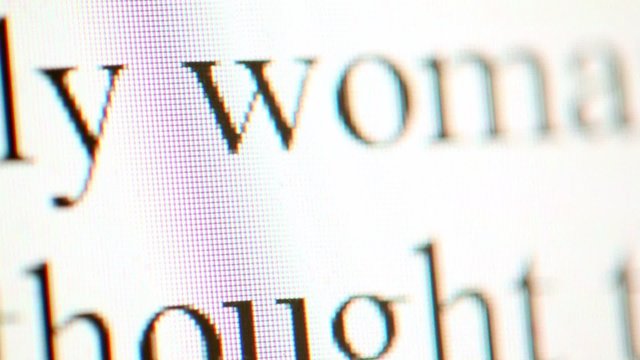 Black text moves upward on white screen very close