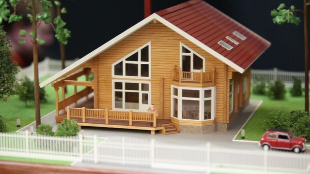 Model of house  at background of unfocused people