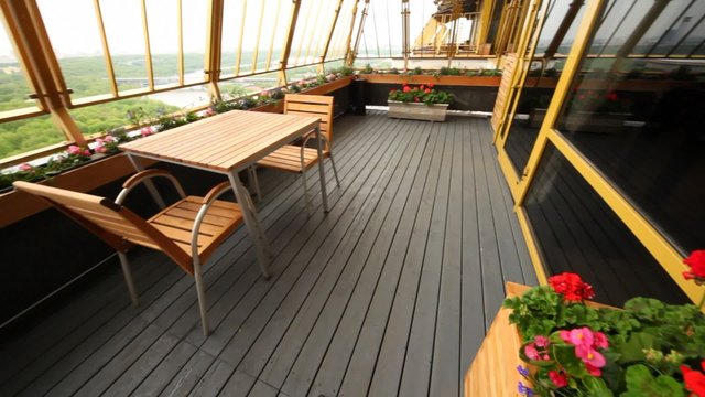 Little table for two stand on restaurant terrace on upper floor