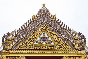 Fototapeta na wymiar Detail of ornately decorated temple roof