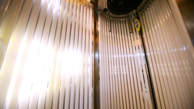 Vertical solarium stands with an open door