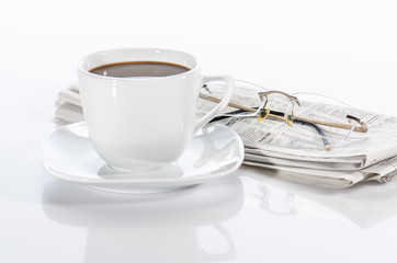 Cup of coffee, the newspaper and the glasses