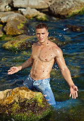 young attractive man staying in the sea