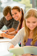 Teens study in high-school library reading student