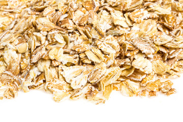 Heap of dry rolled oats isolated on white background