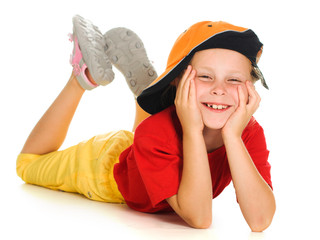 A cheerful little child with funny cap is lying