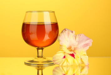 glass with cocktail and gladiolus bud