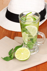 Mojito and a hat on a wooden background