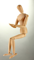 wooden mannequin, on grey background