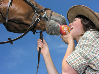young cowgirl and her friend eating an apple