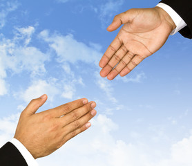 Businessman hand is reaching out in the sky for help