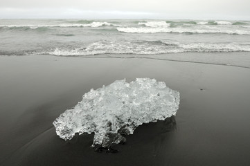 Melting ice on volcanic coast at Jokulsarlon lagoon..