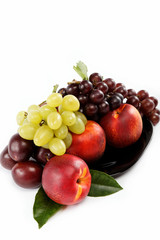 Fruits nectarine and a bunch of grapes isolated against white ba