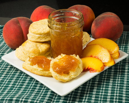 Plate of biscuits with peaches and peach jam