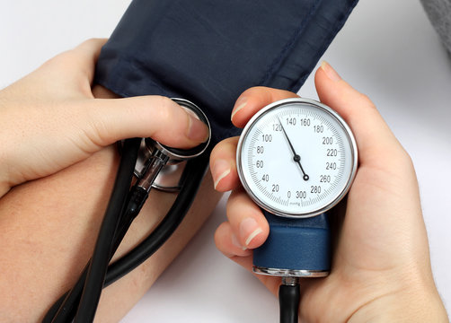 Doctor measuring blood pressure of a patient